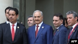Le maréchal Khalifa Haftar, chef d'état-major libyen de l'armée nationale libyenne de l'est libyen, 2e à gauche, se tient avec sa délégation sur les marches de l'Elysée à la suite de la conférence internationale sur la Libye à Paris le 29 mai 2018.