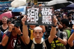 People demonstrate outside the police station during a protest against the Yuen Long attacks in Yuen Long, New Territories, Hong Kong, July 27, 2019.