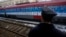 A railroad worker stands by the first train decorated with letters that read "Kosovo is Serbian" written in twenty languages departing from Belgrade to Mitrovica, Kosovo, Jan. 14, 2017.