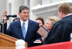 FILE - Gov. Joe Manchin, left, is sworn into office for a second term at the Capitol in Charleston, West Virginia, Jan. 19, 2009.