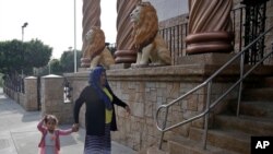 FILE - Worshipers enter a branch of La Luz del Mundo church in LA. California's top prosecutor believes there are more victims of child sex abuse than those listed in charges against Mexico-based megachurch leader La Luz del Mundo and several followers. 