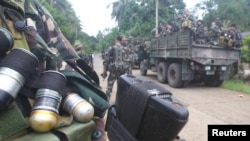 Soldiers stand guard on a road as they are deployed to remote villages in Jolo, Sulu southern Philippines, Oct. 17, 2014. 