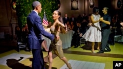 President Barack Obama and first lady Michelle Obama do the tango with dancers during a state dinner at the Centro Cultural Kirchner, March 23, 2016, in Buenos Aires, Argentina.