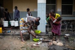 A family from Nharrime takes shelter in the Samora Machel school to take shelter from Tropical Cyclone Eloise in Beira, Mozambique, Jan. 23, 2021. (UNICEF/Franco/Handout via Reuters)