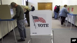 Early voters fill their ballots at the Douglas County Election Commission office, in Omaha, Neb. 29 Oct. 2010