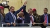 FILE - Eritrean President Isaias Afwerki, 2nd left, and Ethiopia's Prime Minister Abiy Ahmed, center, hold hands as they wave at the crowds in Addis Ababa, Ethiopia, July 15, 2018.