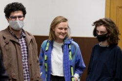 DOXA magazine editors from left, Armen Aramyan, Natalya Tyshkevich and Alla Gutnikova wait for a court session in Moscow, Russia, Apr. 14, 2021.