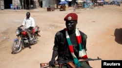 An SPLA soldier drives in a vehicle in Juba December 21, 2013. Troops were deployed around the city again in March after clashes at an army barracks claimed the lives of at least 24 soldiers. 