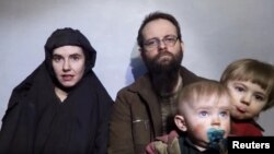 A still image from a video posted by the Taliban on social media on Dec. 19, 2016, shows American Caitlan Coleman speaking next to her Canadian husband, Joshua Boyle, and their two sons. 
