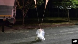 This photo provided by South Korea Defense Ministry, shows balloons with trash presumably sent by North Korea, in South Chungcheong Province, South Korea, May 29, 2024.