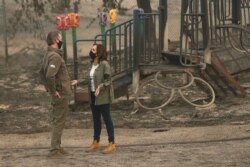 California Gov. Gavin Newsom and Democratic vice presidential candidate Sen. Kamala Harris have a discussion about the damage during the Creek Fire in front of the Pine Ridge Elementary schoolyard, in Auberry, California, Sept. 15, 2020.