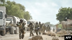 FILE - Soldiers with the African Union Mission in Somalia march through the town of Golweyn in Somalia's Lower Shabelle region, August 30, 2014, in this handout picture released by the African Union-United Nations Information Support Team.