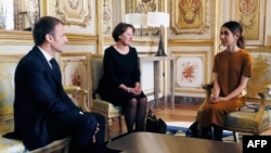 French President Emmanuel Macron (L) speaks with 2018 Nobel peace prize Iraqi Yazidi human rights activist Nadia Murad Basee Taha (R), during a meeting at the Elysee palace in Paris, Oct. 25, 2018.