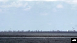 FILE - Ongoing reclamation of Subi Reef by China is seen from Pag-asa Island in the Spratly Islands, South China Sea, western Palawan Province, Philippines, May 2015.