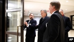 Former White House strategist Steve Bannon, center, is escorted from a House Intelligence Committee meeting where he was interviewed behind closed doors on Capitol Hill, in Washington, Jan. 16, 2018. 