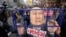 Protesters carry a caricature depicting an imprisoned South Korean President Yoon Suk Yeol as they march to the presidential office after a rally demanding his impeachment in Seoul, South Korea, Dec. 12, 2024. 