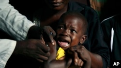 A boy reacts as he receives a yellow fever vaccine injection in the Kisenso district of Kinshasa, Congo, on July 21, 2016.
