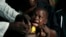 FILE - A boy reacts as he receives a yellow fever vaccine injection in the Kisenso district of Kinshasa, DRC, July 21, 2016.