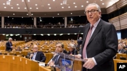 EU Commission President Jean Claude Juncker, left, addresses Members of European Parliament on Brexit during a plenary session at the European Parliament in Brussels on Jan. 30, 2019. 