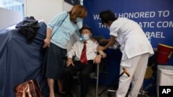 Yehuda Widawsky, a 102-year-old Holocaust survivor, receives a third Pfizer-BioNTech COVID-19 vaccine at a hospital in Tel Aviv, Israel, Aug. 1, 2021.
