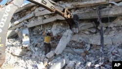 This photo provided by the Syrian Civil Defense White Helmets, which has been authenticated based on its contents and other AP reports, shows White Helmet civil defense workers after an explosion in north Syria, Aug. 12, 2018.