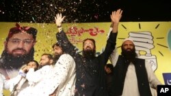 Sheikh Yaqub (C) candidate of the newly-formed Milli Muslim League party, waves to his supporters at an election rally in Lahore, Pakistan, Sept. 14, 2017.