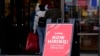 FILE - A hiring sign is displayed outside of a retail store in Vernon Hills, Illinois, Nov. 13, 2021.
