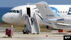 A man believed to be the hijacker of the EgyptAir Airbus A-320, which was diverted to Cyprus, leaves the plane before surrendering to security forces after a six-hour standoff on the tarmac at Larnaca airport's largely disused old terminal on March 29, 20