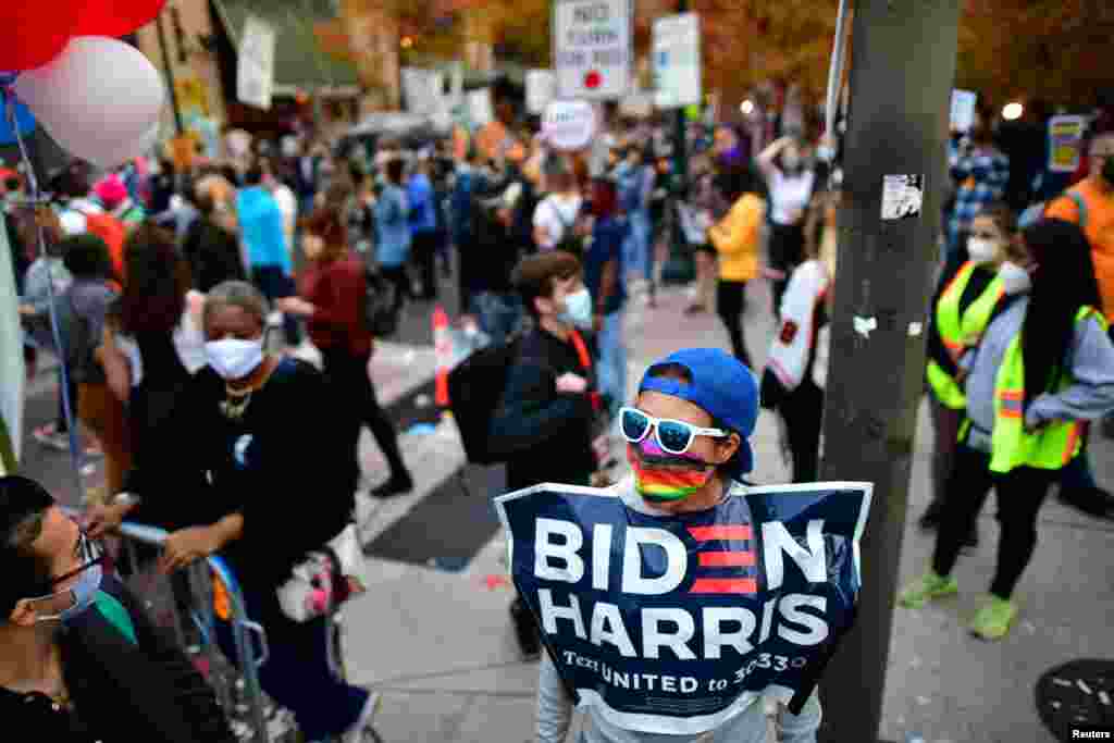 People gather after Democratic presidential candidate Joe Biden overtook President Donald Trump in the Pennsylvania general election vote count, in Philadelphia, Pennsylvania, Nov. 6, 2020.