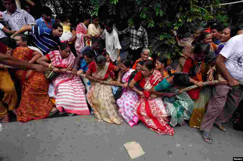 Hindu devotees lose their balance as they pull the &quot;Rath&quot; or the chariot of Lord Jagannath, on the last day of the week-long celebration of Rath Yatra, or chariot procession, in Kolkata, India.