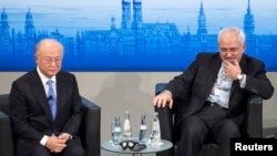 FILE - International Atomic Energy Agency (IAEA) Director General Yukiya Amano (L) and Iran's Foreign Minister Mohammad Javad Zarif attend the annual Munich Security Conference in Germany, Feb. 2, 2014.