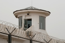 FILE - A guard stands in a watchtower in Kashgar, Xinjiang Uyghur Autonomous Region, China, May 3, 2021.