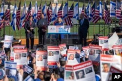 Senator Jon Ernst (tengah) berpidato dalam demo solidaritas Israel didampingi oleh Ketua DPR AS Mike Johnson, Pemimpin Minoritas DPR Hakeem Jeffries, dan Pemimpin Mayoritas Senat Chuck Schummer, di Washington DC, Selasa, 14 November 2023. (Foto: Mark Schiefelbein/AP)