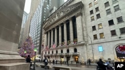 FILE - A scooter passes the New York Stock Exchange in New York's Financial District, Dec. 17, 2024.