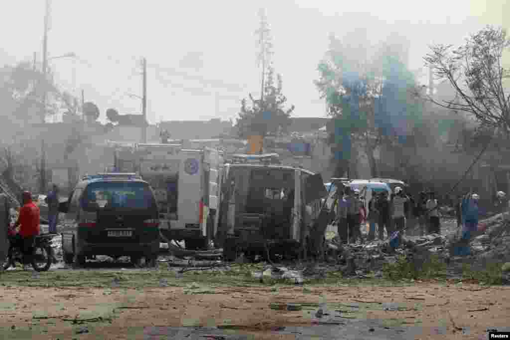 People look for survivors near a damaged ambulance after double airstrikes on the rebel held Bab al-Nairab neighborhood of Aleppo, Syria, Aug. 27, 2016.