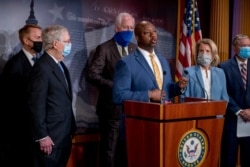 Sen. Tim Scott, center, accompanied by Sen. James Lankford, Senate Majority Leader Mitch McConnell of Ky., Sen. John Cornyn, Sen. Shelley Moore Capito, R-W.Va., and Sen. Lindsey Graham, speaks at a news conference on Capitol Hill, June 17, 2020.
