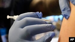 FILE - Some U.S. adults may get updated COVID-19 shots this fall, as government advisers voted Tuesday that it's time to tweak booster doses to better match the most recent virus variants.