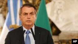 FILE - Brazil's President Jair Bolsonaro talks at the government house in Buenos Aires, Argentina, June 6, 2019.