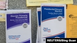 English and Spanish-language sample ballots and voter information pamphlets for the California Democratic presidential primary are seen at a polling place in Del Mar, Calif., on Super Tuesday, March 3, 2020. 