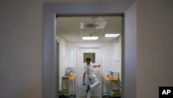 A doctor disinfects his shoes as he leaves the ICU unit of Rome's San Filippo Neri Hospital's Covid department, in Rome, April 9, 2020.