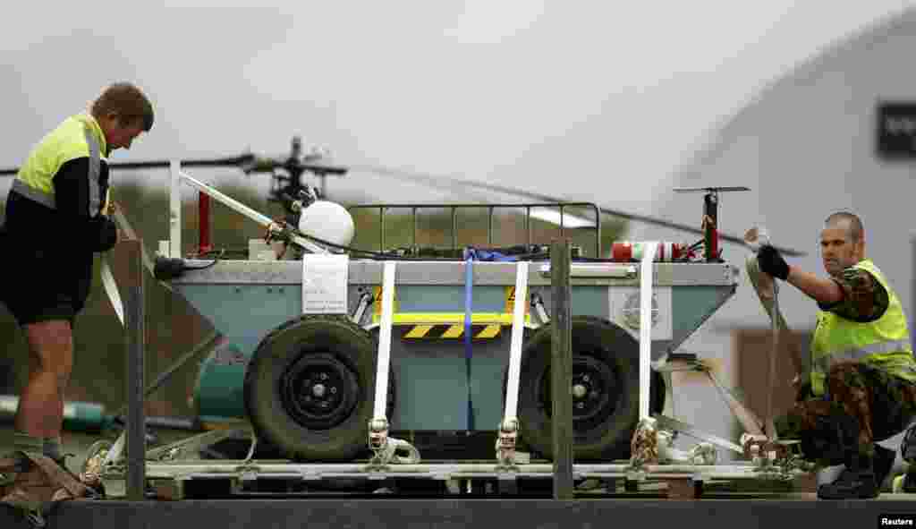 A New Zealand soldier secures a robot from Australia onto a truck at Hokitika airport on New Zealand's west coast, Nov. 24, 2010. The robot will be used to assist the rescue effort of 29 miners trapped underground after an explosion at the nearby Pike River coal mine. (Reuters)