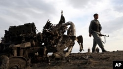 Afghan security forces gather at the site of Monday's attack near the Bagram Air Base, north of Kabul, Afghanistan, April 9, 2019.
