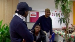 Omer Mas Capitolin, left, and youngsters at the Maison Communautaire pour le Developpement Solidaire community center in Paris. (Lisa Bryant/VOA)