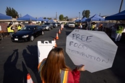 Cars line-up as the Los Angeles Regional Food Bank distributes food outside a church during the outbreak of COVID-19 in Los Angeles, California, Nov. 19, 2020.