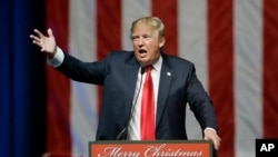 FILE - Republican presidential candidate, businessman Donald Trump addresses supporters at a campaign rally.