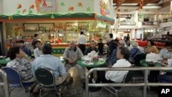 FILE - A group of Vietnamese Americans eat lunch at the Asian Garden mall in the Little Saigon section of Westminster, California.