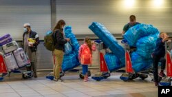 People line up to get on an overseas flight at OR Tambo International Airport in Johannesburg, South Africa, Nov. 26, 2021. 