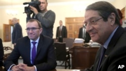 FILE - U.N. Special Adviser of the Secretary-General Espen Barth Eide, left, and Cyprus' President Nicos Anastasiades sit during their meeting at the presidential palace in divided capital Nicosia, Cyprus, Nov. 28, 2016.