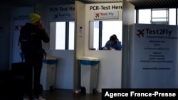 A passenger waits for a Covid-19 test at the Schiphol airport, Netherlands, Nov. 29, 2021. 