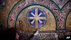A restoration expert works on a mosaic inside the Church of the Nativity, in the West Bank city of Bethlehem, Feb. 4, 2016.